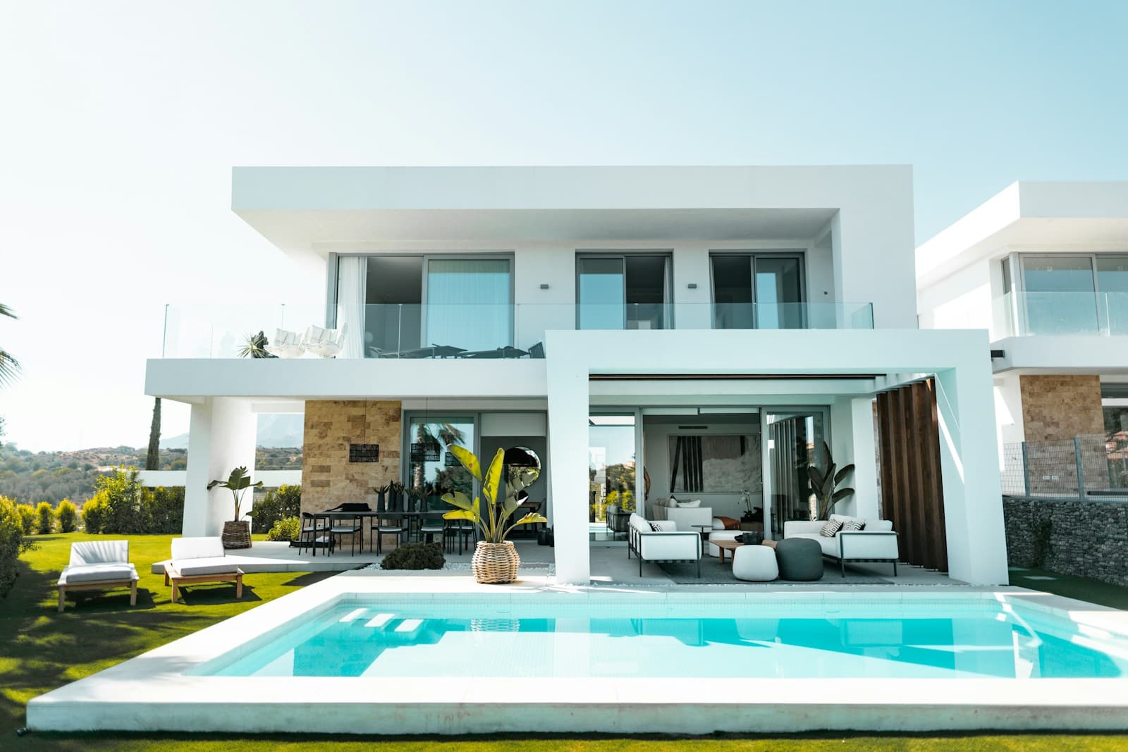A white villa with a pool